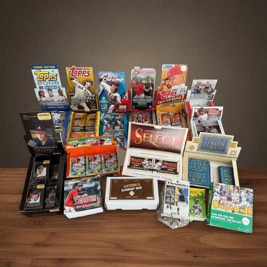 Collection of various baseball trading card packs on a wooden table
