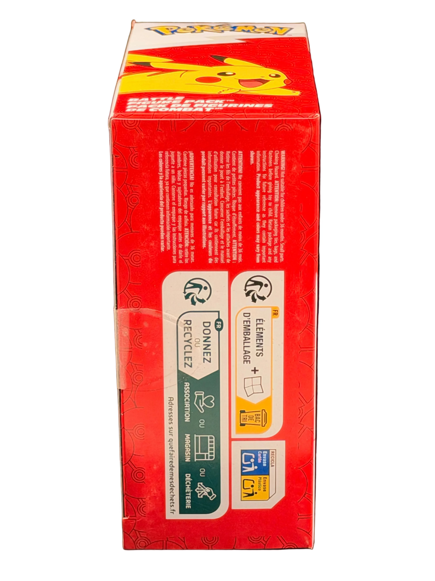 A red Pokémon product box standing upright against a black background, showing recycling icons and small printed text on the side panel.