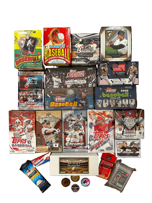 Collection of baseball trading card packs and boxes on a wooden surface