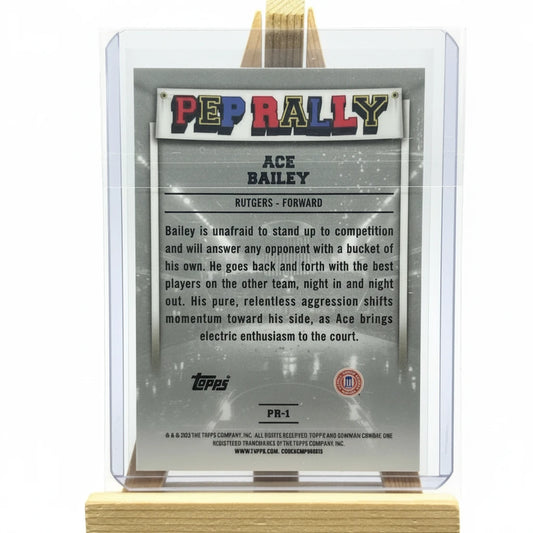 Trading card of Ace Bailey in a clear display case with a wooden stand.