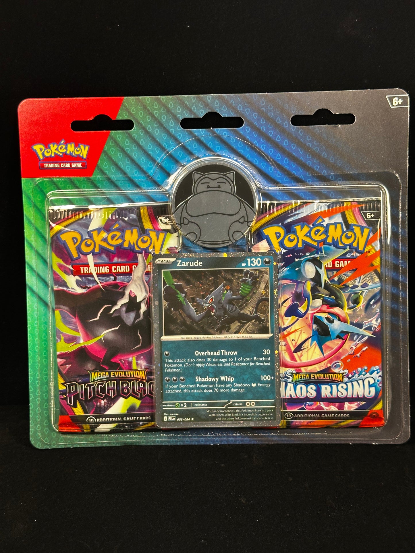 Pokémon Trading Card Game Mega Evolution Starter pack in its original blister packaging, featuring the Pokémon logo and cards including Zarude and a silver Snorlax collectible coin.
