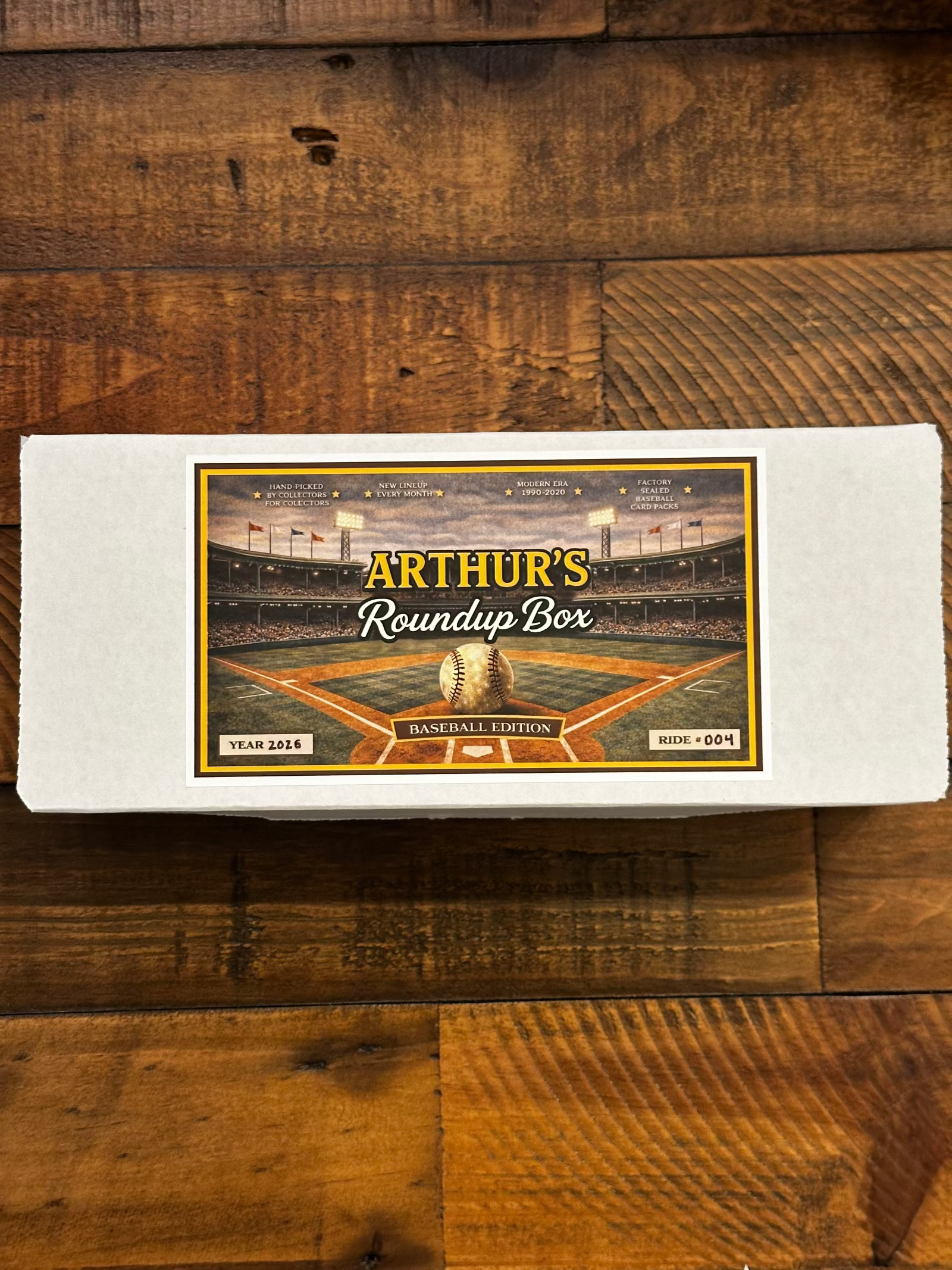 Picture of Baseball Card storage box on wooden table with Arthur's Roundup Box logo