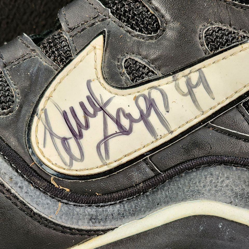 Warren Sapp autograph with number 99 inscription on Nike football cleat Swoosh