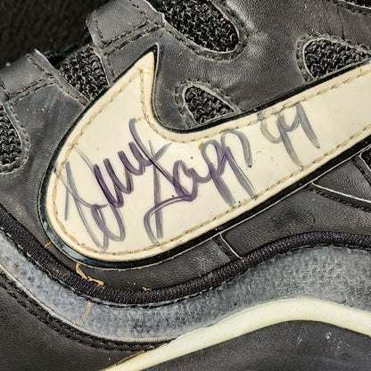 Warren Sapp autograph with number 99 inscription on Nike football cleat Swoosh