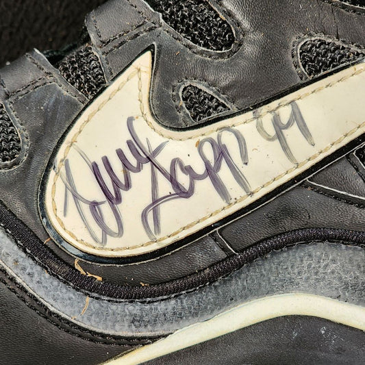Warren Sapp autograph with number 99 inscription on Nike football cleat Swoosh