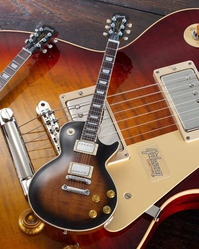 Close-up of a Gibson electric guitar with a sunburst finish.