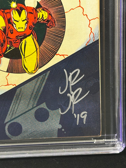 Close-up of a signed comic book card inside a clear protective case, featuring Iron Man artwork and a white autograph of John Romita Jr.